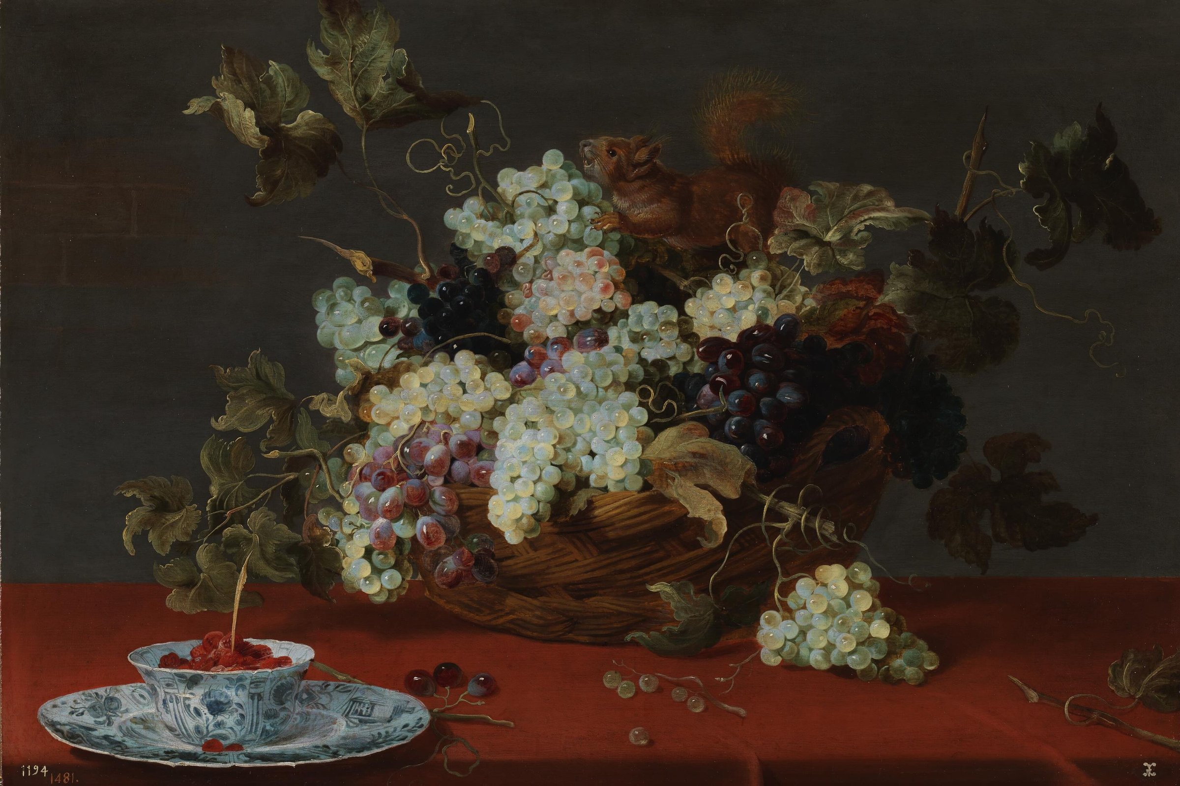 A fruit still life with a basket of grapes and a squirrel on a table by Frans Snyders